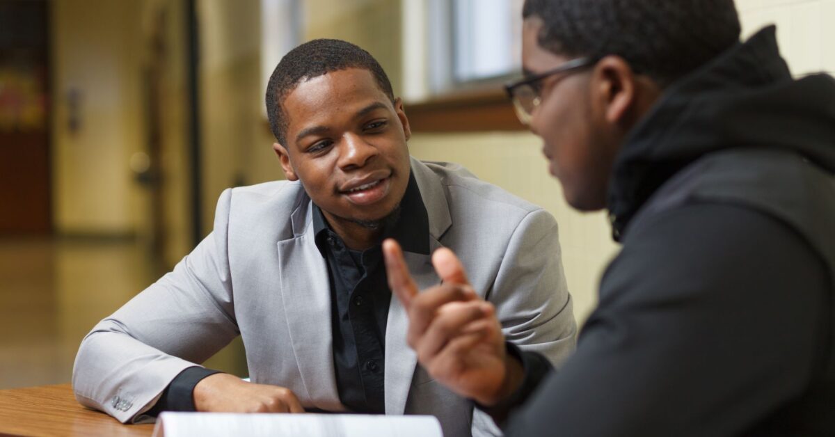 Student talking to volunteer coach