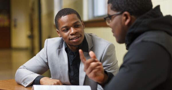 Student talking to volunteer coach
