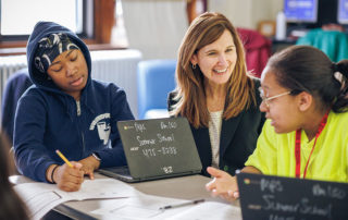 Brenda Campbell mentoring two students during the Money Coach Program