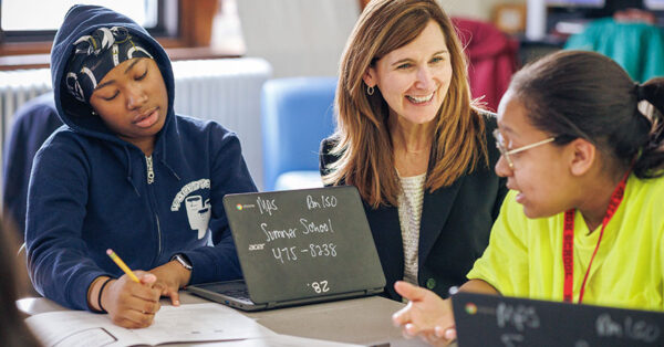 Brenda Campbell mentoring two students during the Money Coach Program